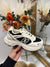 Cream/black “NADIA” trainers